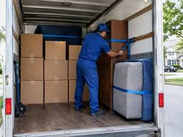 Un déménageur arrime les meubles et les cartons dans le camion
